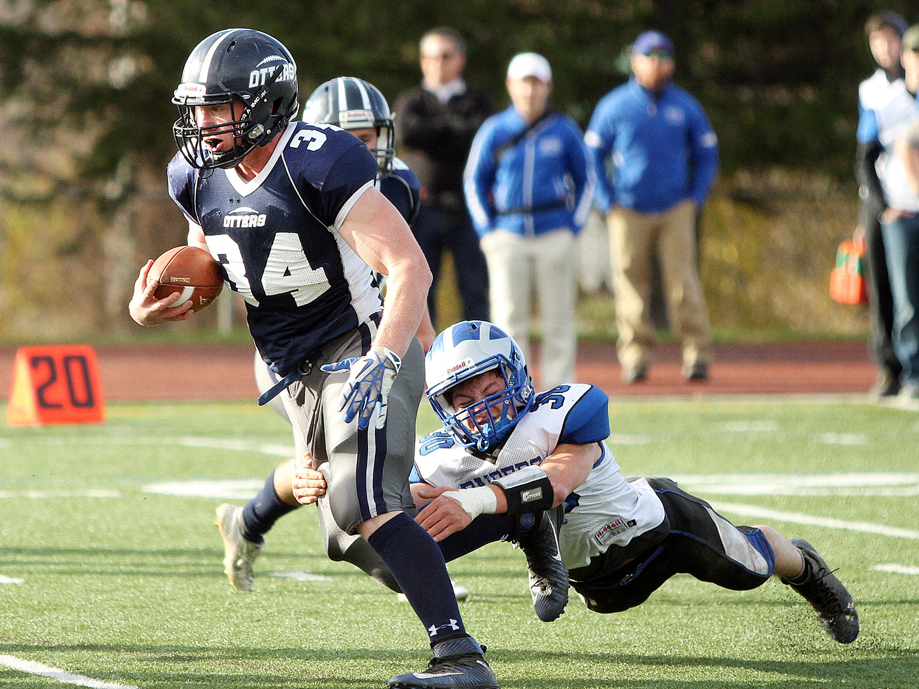 Otter Valley’s Carson Leary eludes U-32’s Devin Hanson in the Otters’ 33-14 win over the Raiders in the Division III football state title game Nov. 7.