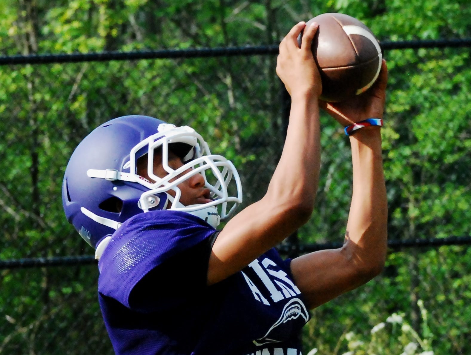 Aiken sophomore receiver Dequan Freeman looks in a completed pass for a score during 7-on-7 practice.