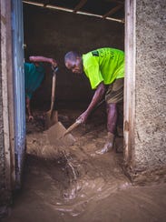 A man in the Haitian region of Nippes in a flooded