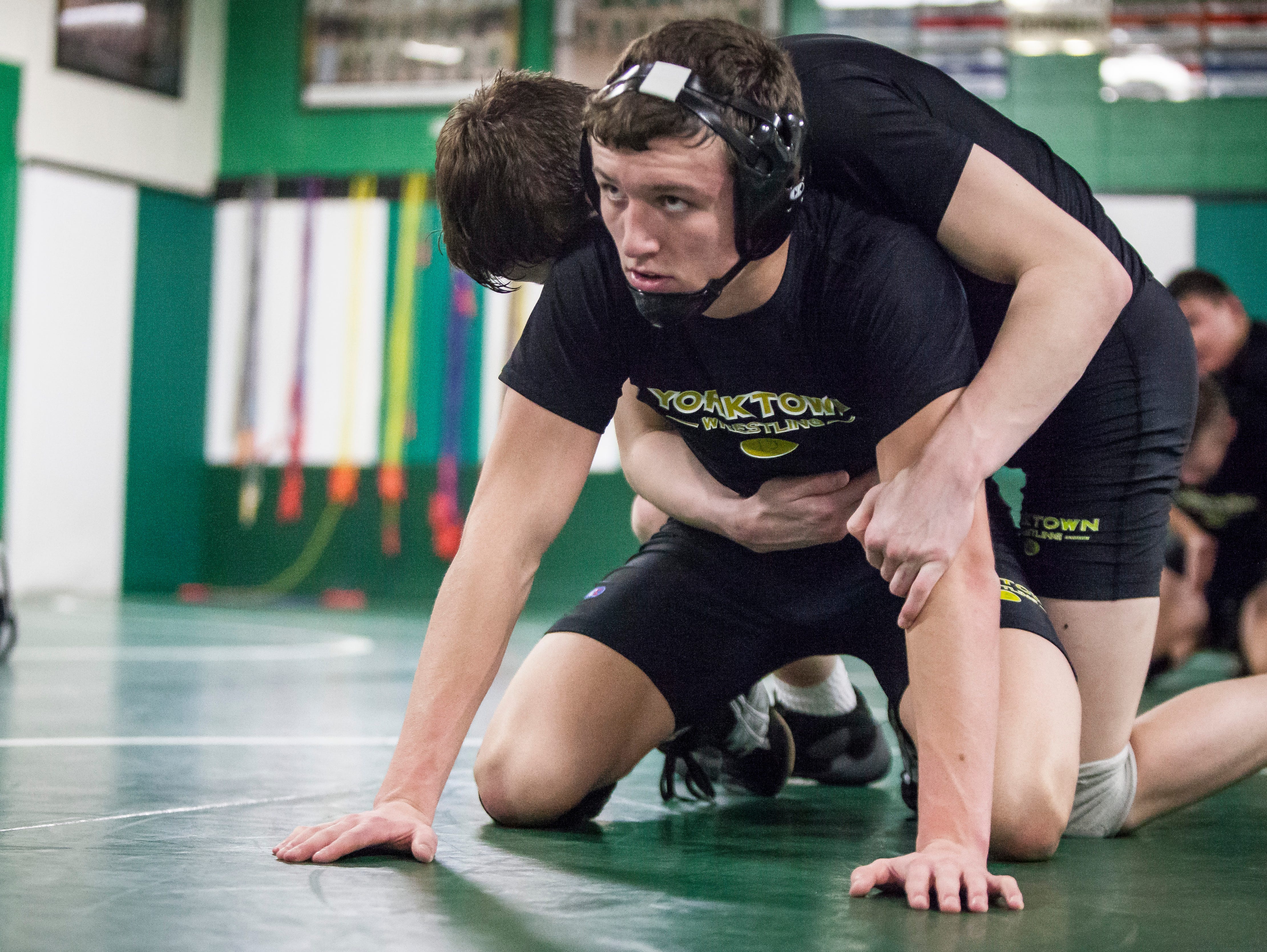 Cael McCormick practices with another Yorktown wrestler at Yorktown High School. This season will be McCormick's last for his high school career.