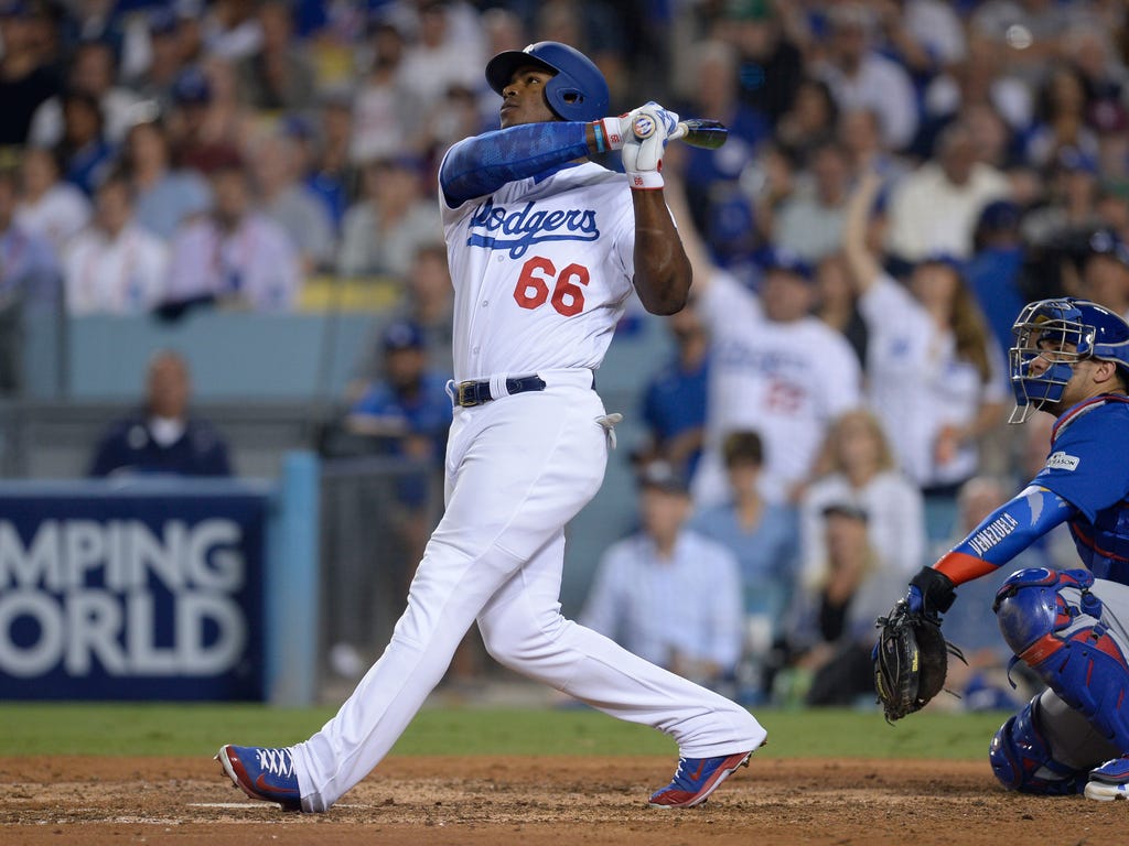 Dodgers slugger Yasiel Puig watches his solo home run leave the yard during seventh inning of Game 1 of the NLCS in Los Angeles.