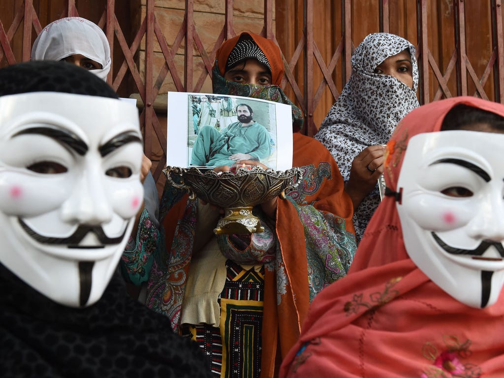 Relatives of missing Pakistani residents wear Guy Fawkes masks as they take part in a protest to mark Baloch Martyrs Day in Quetta.