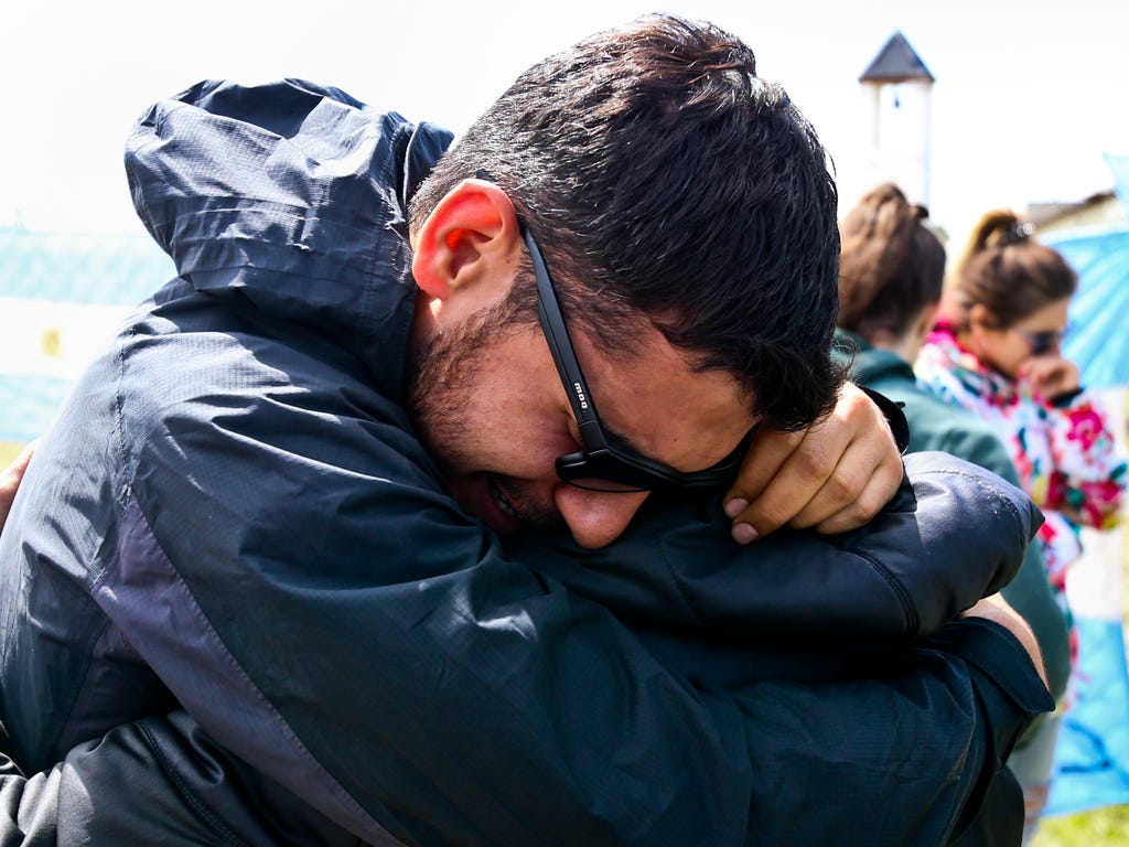 Relatives and friends of Alejandro Tagliaprieta, a crew member on the missing ARA San Juan submarine, embrace at the navy base in Mar de Plata, Argentina.  The navy says an explosion occurred near the time and place where the sub went missing on Nov.