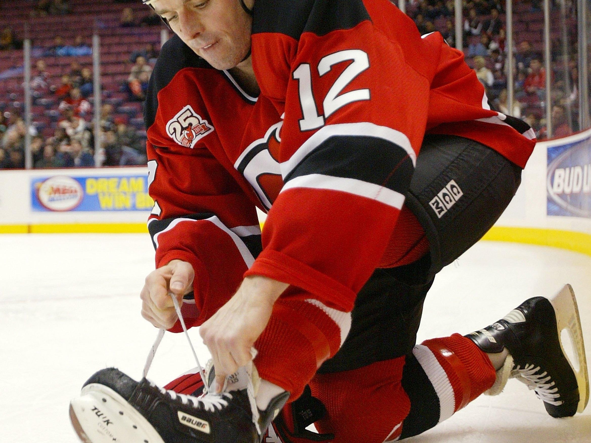Jim Dowd ties his skate during a 2006 Devils game against the Montreal Canadiens.