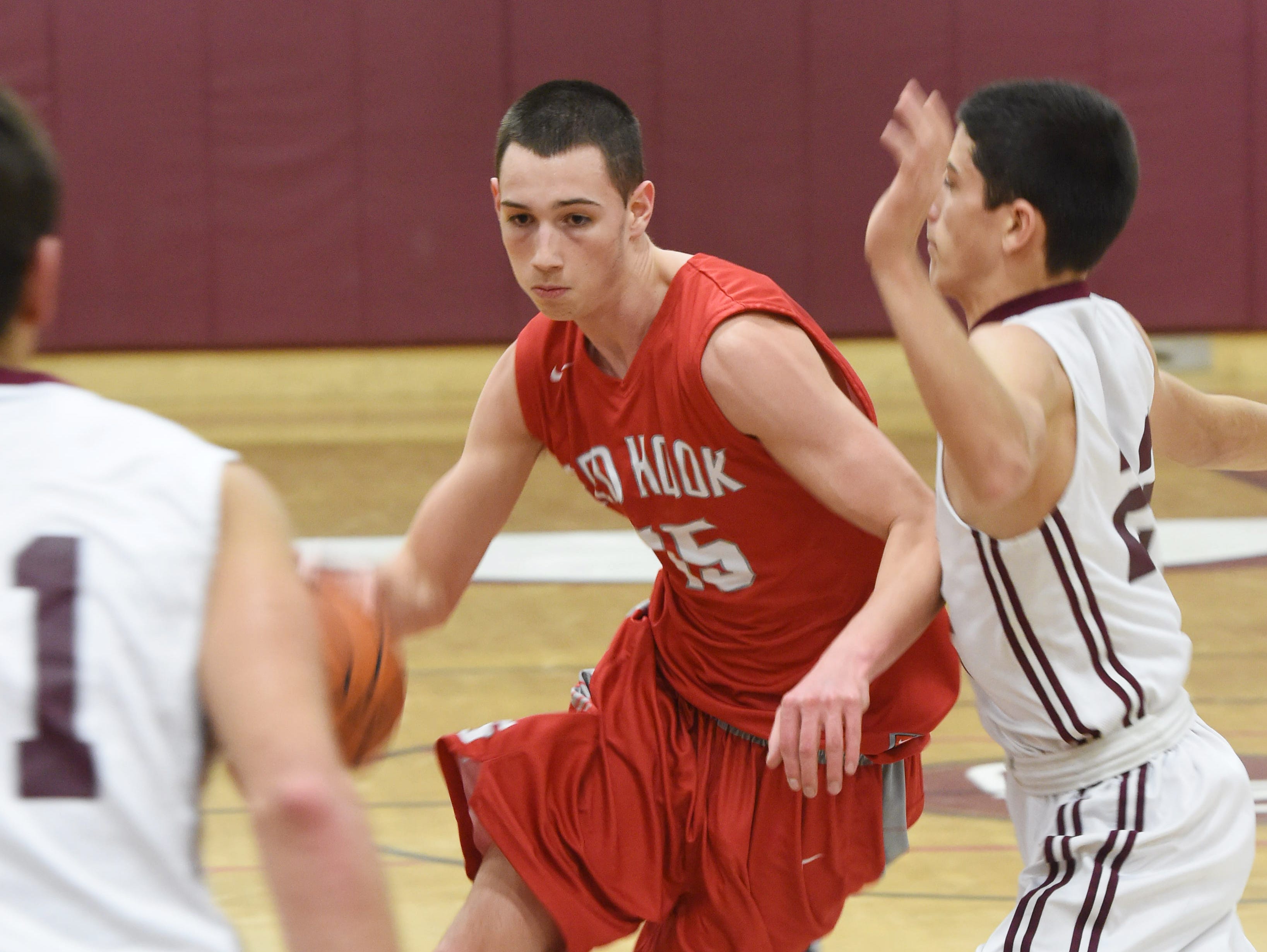 Red Hook's Beau Smith weaves his way through New Paltz's, from left, Michael Krebs and Jimmy Verney during Tuesday's game at New Paltz.
