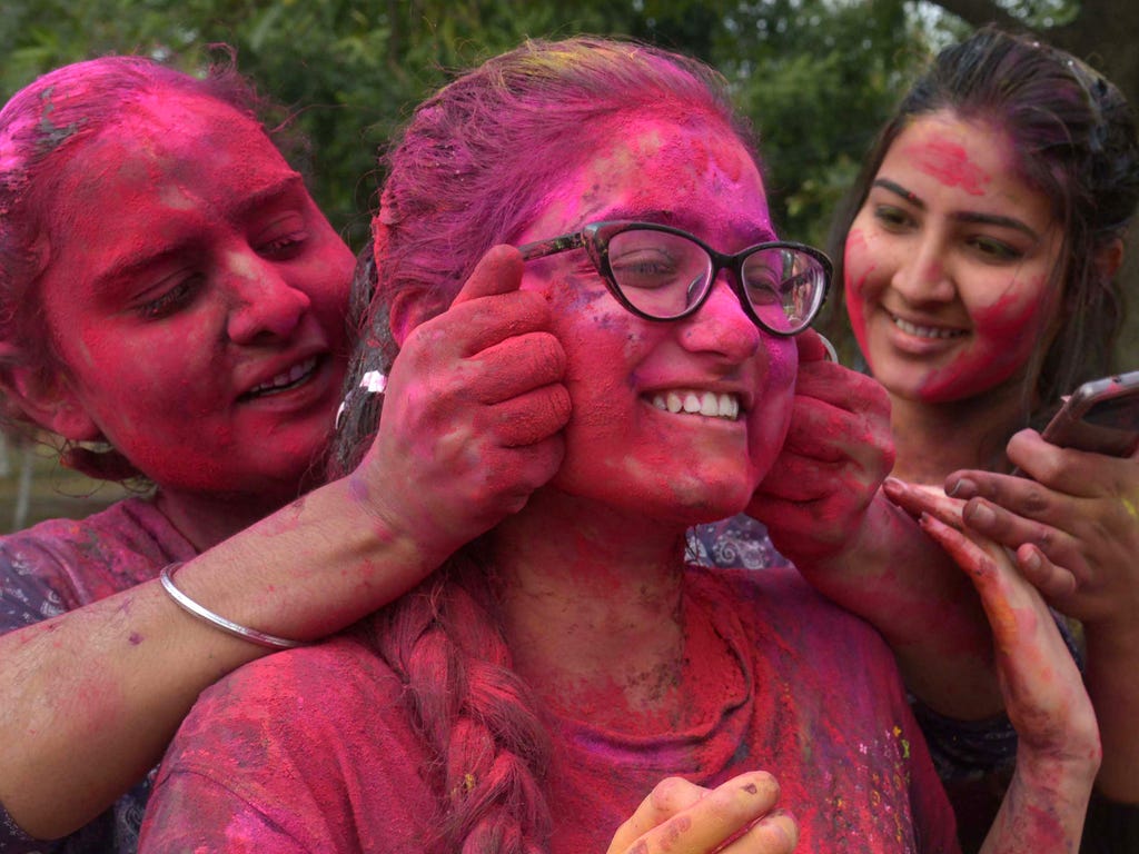 Students with colored powder at Guru Nanak Dev University in Amritsar participate in Holi, the popular Hindu spring festival of colors.