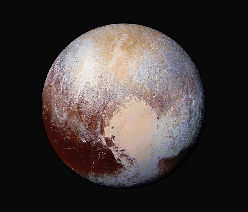 This image made available by NASA on Friday, July 24, 2015 shows a combination of images captured by the New Horizons spacecraft with enhanced colors to show differences in the composition and texture of Pluto's surface.
