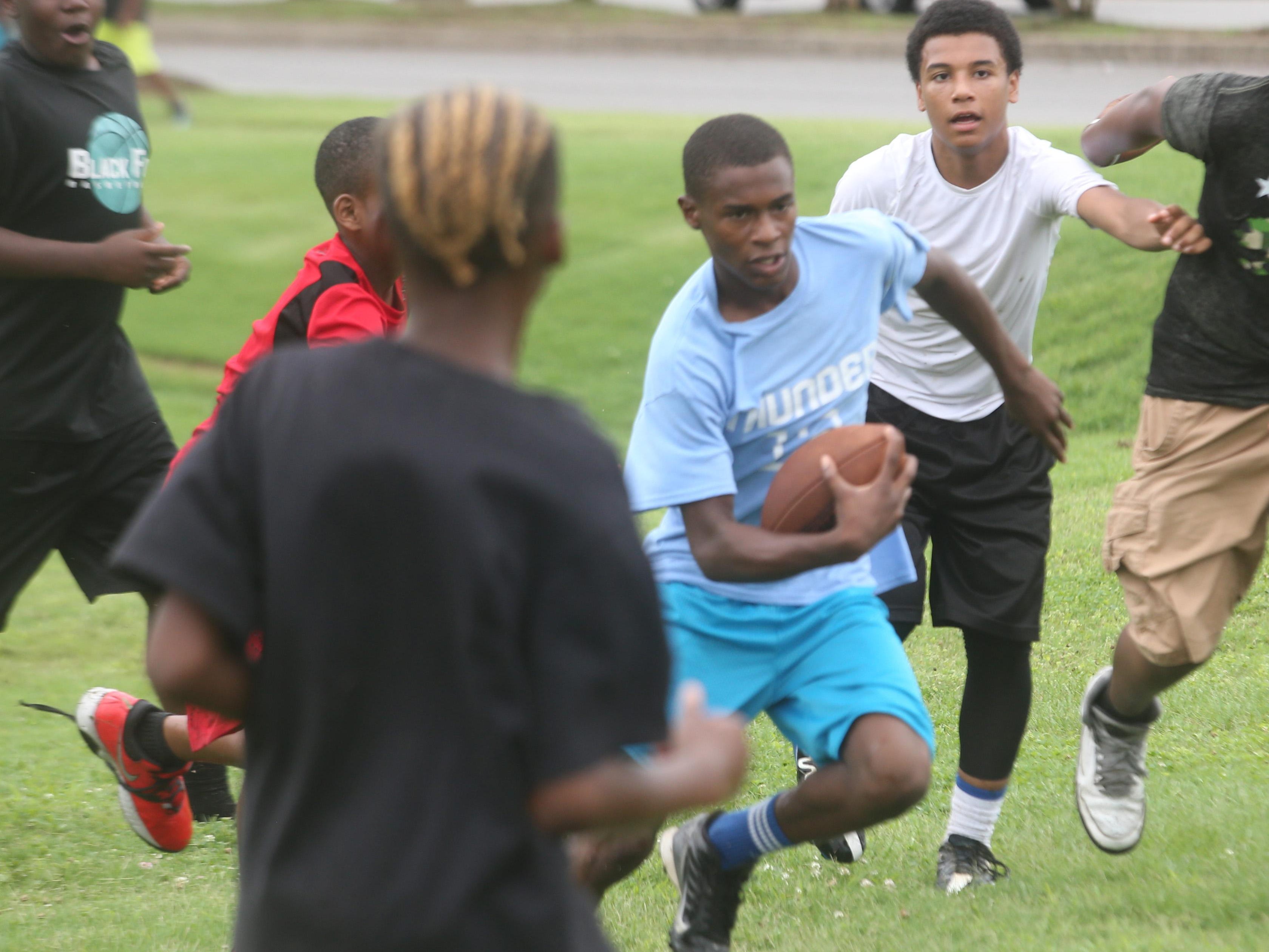 D'lando Spates runs with the ball during the 7-on-7 contest during Thursday's football camp.
