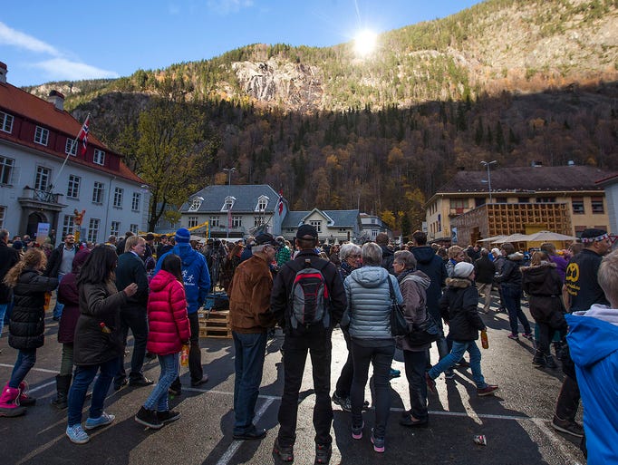 People gather as sunlight reflected off giant mirrors illuminates the town square on Oct. 30 in Rjukan, Norway. Residents of the small town, tucked between steep mountains, normally live in the shade for six months a year.