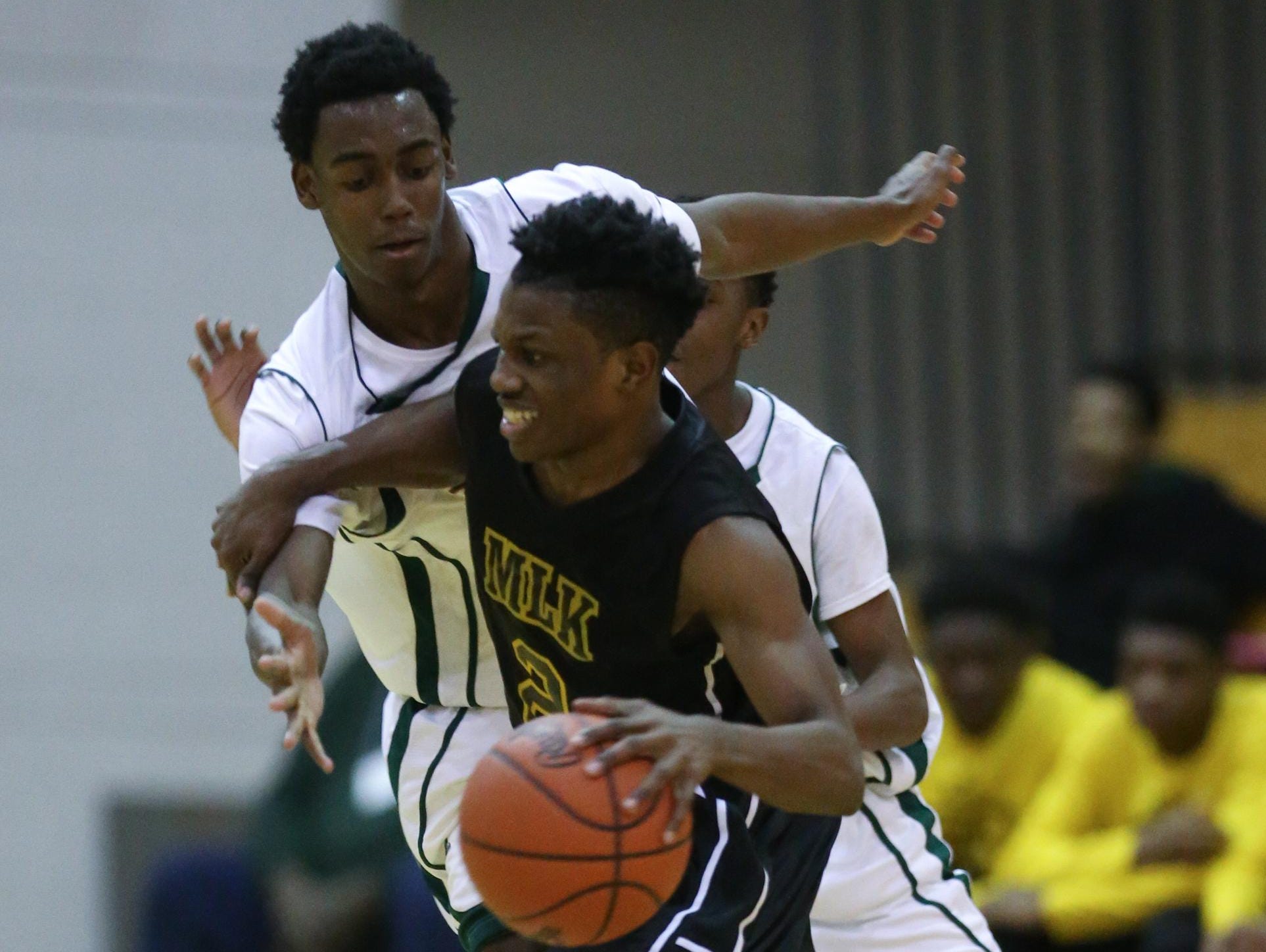 Detroit King’s Jesse Scarber drives against Detroit Douglass’ James Smith during the fourth quarter Tuesday at Detroit Cass Tech. Scarber was King’s defensive hero in the 58-44 win with three steals in the fourth. “We had to step up our defense,” Scarber said.