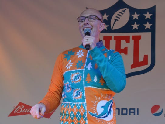 Neil Reynolds wears a Miami Dolphins sweater during