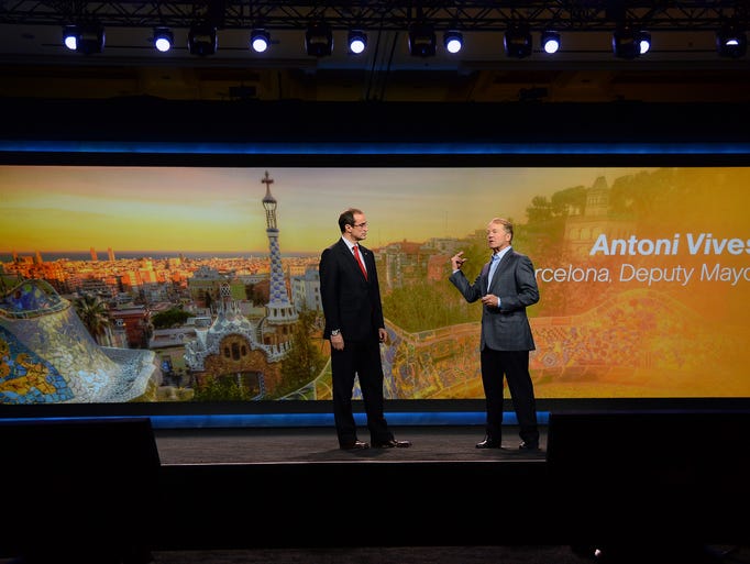 LAS VEGAS, NV - JANUARY 07: Deputy Mayor of Barcelona, Spain Antoni Vives (L) joins Cisco Systems Inc. Chairman and CEO John Chambers as he delivers a keynote address at the 2014 International CES at The Venetian Las Vegas on January 7, 2014 in Las Vegas, Nevada. CES, the world's largest annual consumer technology trade show, runs through January 10 and is expected to feature 3,200 exhibitors showing off their latest products and services to about 150,000 attendees. (Photo by Ethan Miller/Getty Images)