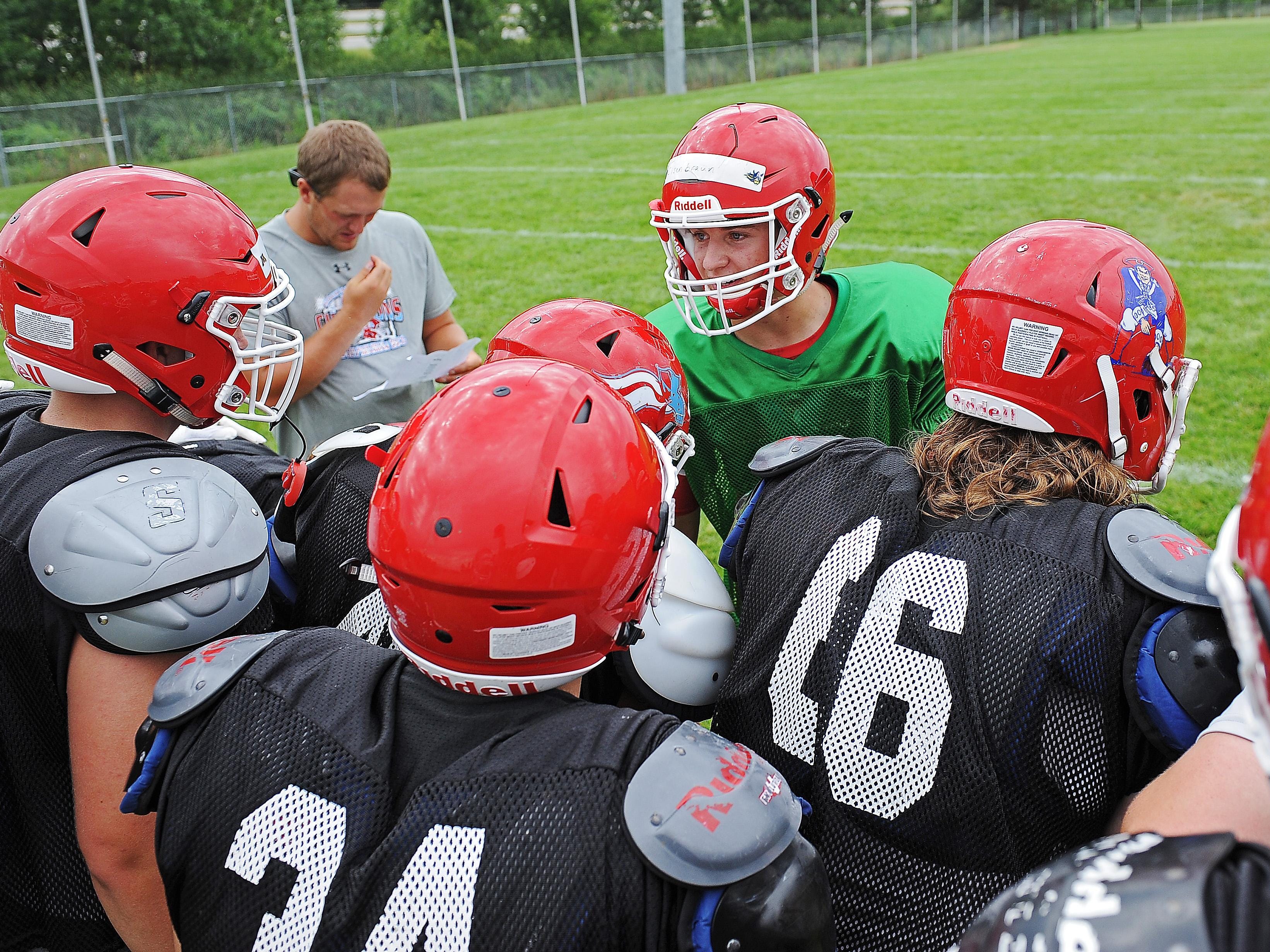 Lincoln quarterback Preston Eisenbraun talks to his teammates in a huddle during a Lincoln High School football practice Thursday, Aug. 11, 2016, at Lincoln High School in Sioux Falls.