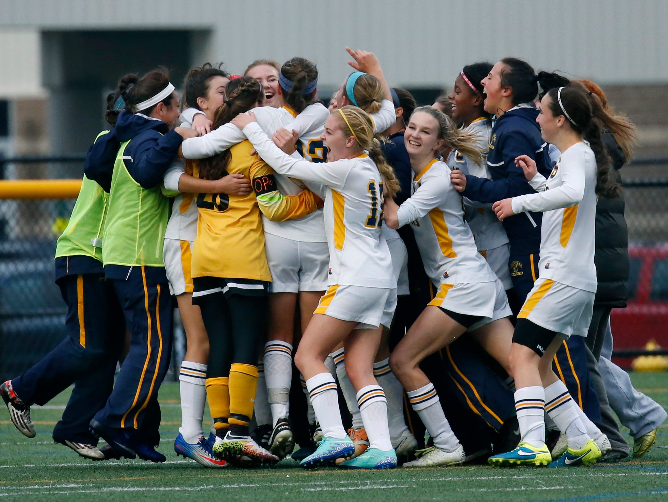 Spencerport celebrates their 2-0 win over Aquinas at Webster Schroeder High School.