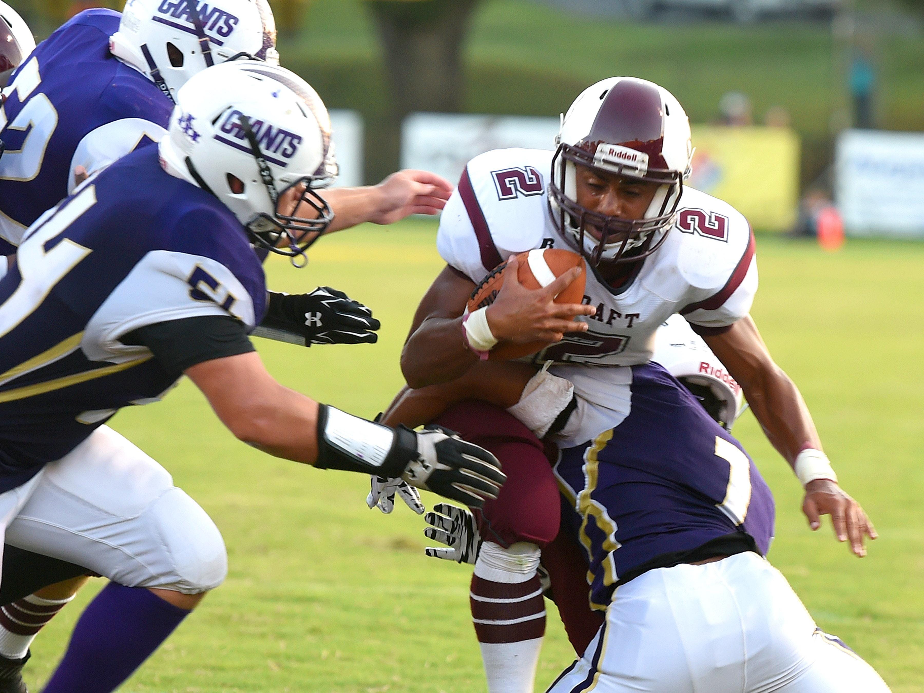 Stuarts Draft’s Marston Jones is tackled by Waynesboro’s Marendon Armon Jones as Waynesboro defenders close in.