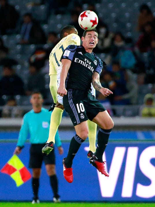 Real Madrid's James Rodriguez (10) and Club America's Michael Arroyo vie for the ball in the air during their semifinal match at the FIFA Club World Cup soccer tournament in Yokohama, near Tokyo, Thursday, Dec. 15, 2016. (AP Photo/Shizuo Kambayashi)