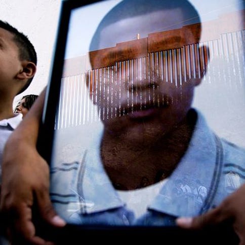 Araceli Rodriguez holds a photo of her son, Jose Antonio Elena Rodriguez, during a Nov. 2, 2012, protest march along the border fence in Nogales. Family, friends and human-rights groups protested the Border Patrol's use-of-force policies.