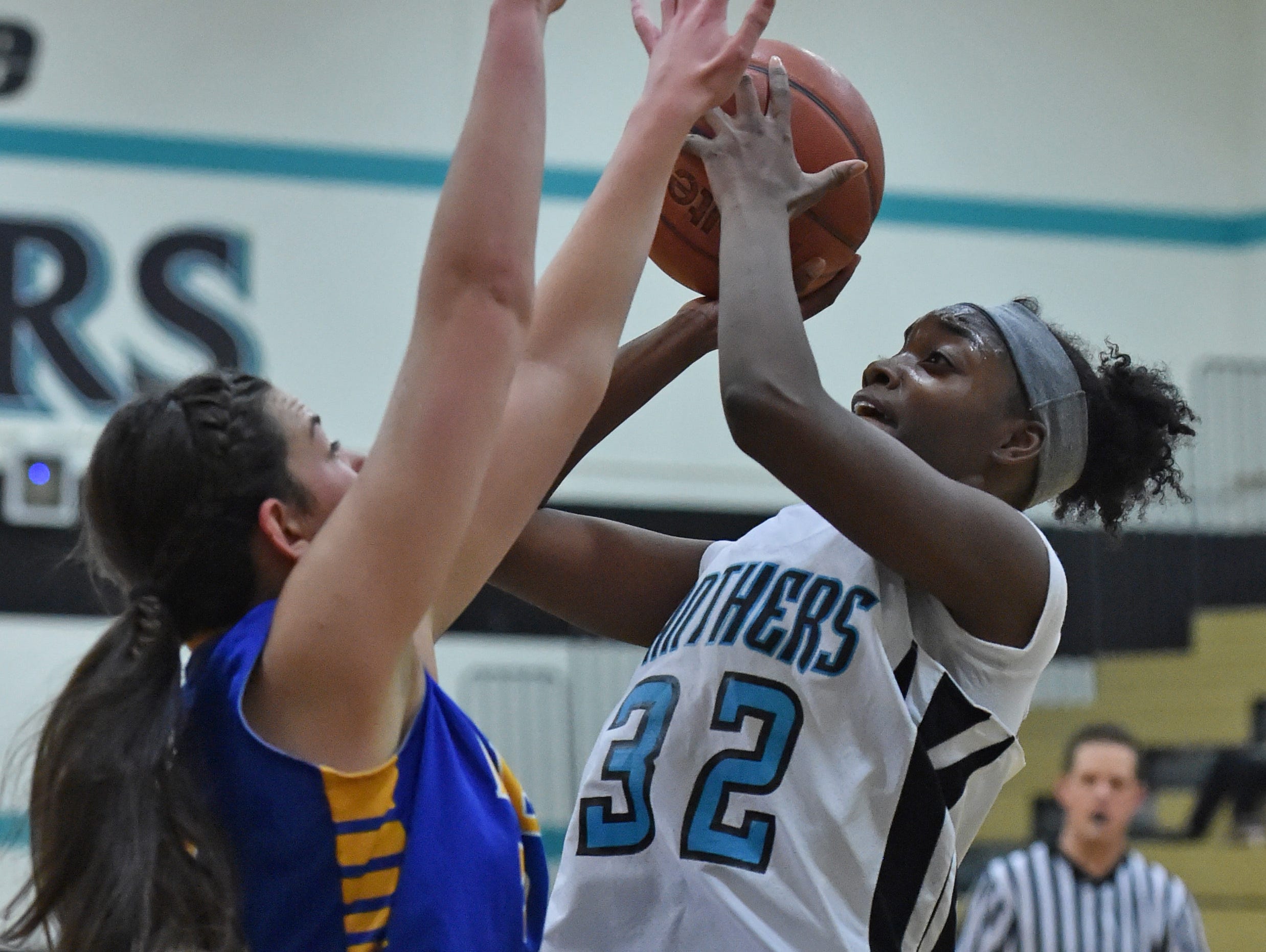 North Valleys' Passion Burrell shoots with Reed's Tori Baer covering her during Tuesday's game at North Valleys