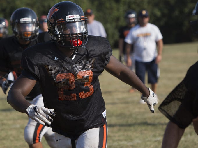 Northeastern's Shamari Young, left, rushes the quarterback.