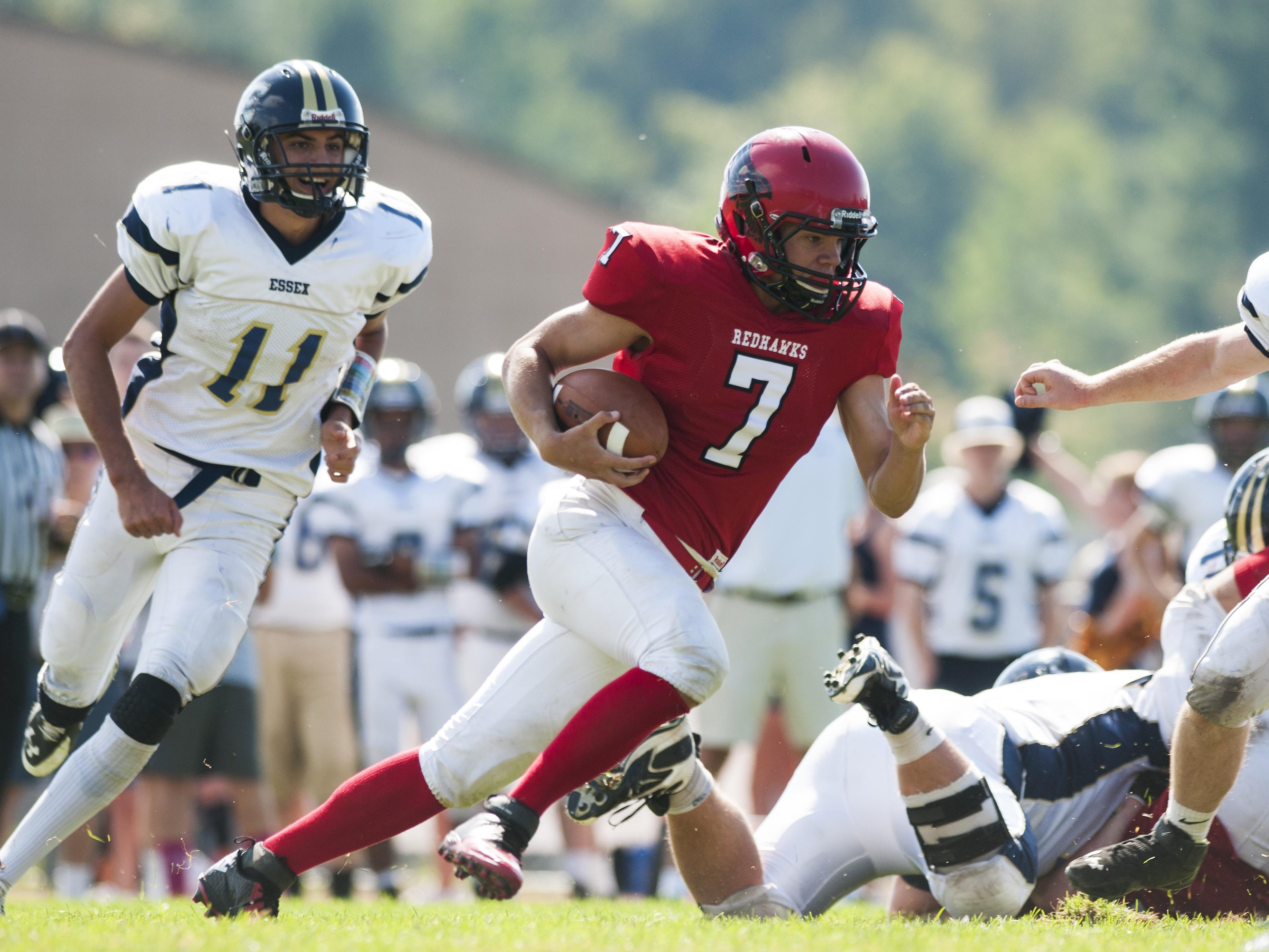 CVU quarterback Andrew Bortnick runs with the ball during a high school football against Essex in Hinesburg on Saturday.
