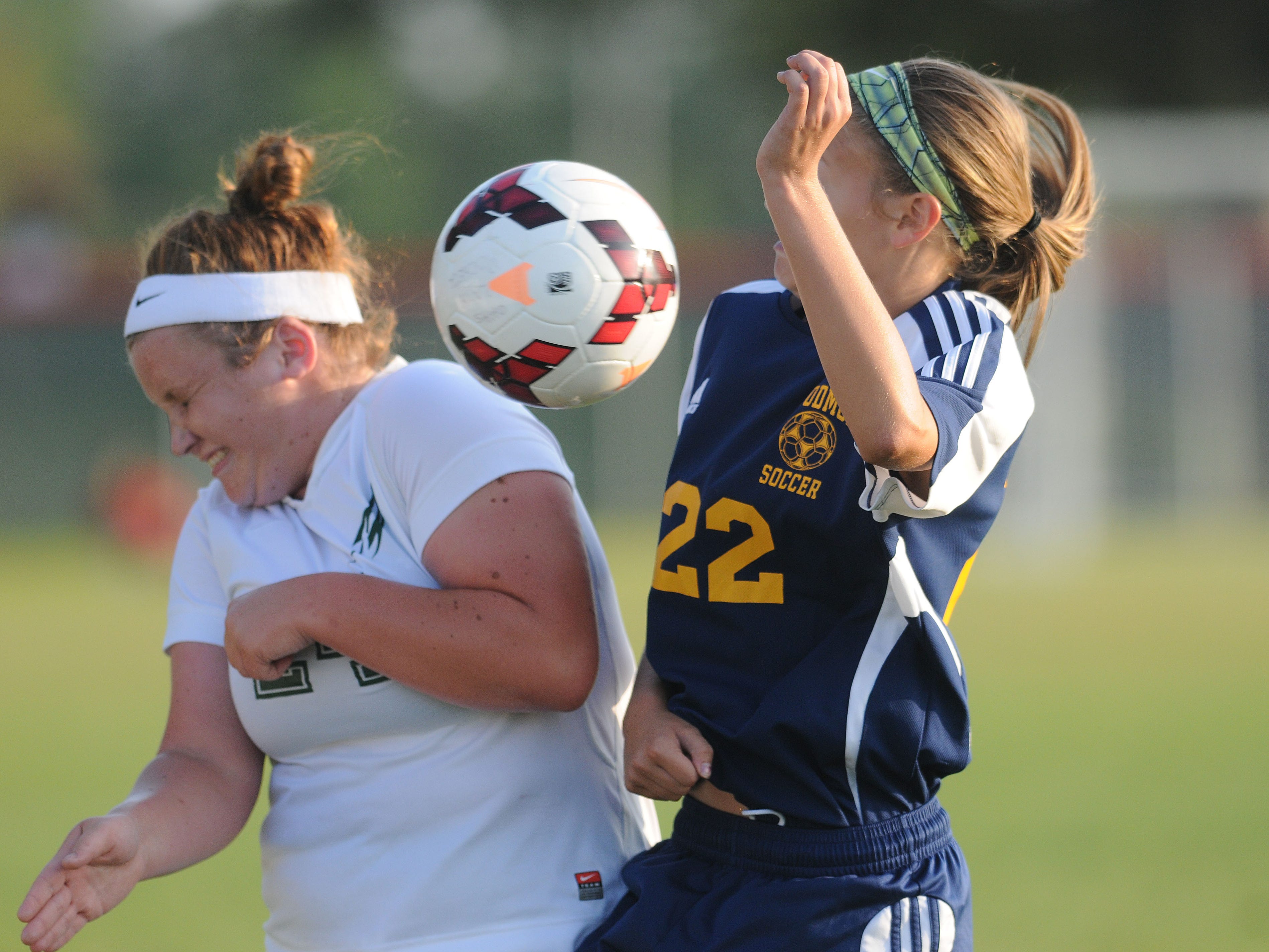 Oak Harbor's Ally Croy and Woodmore's Liz Koenig fight for the ball during a soccer game on Monday, Aug 18, 2014.