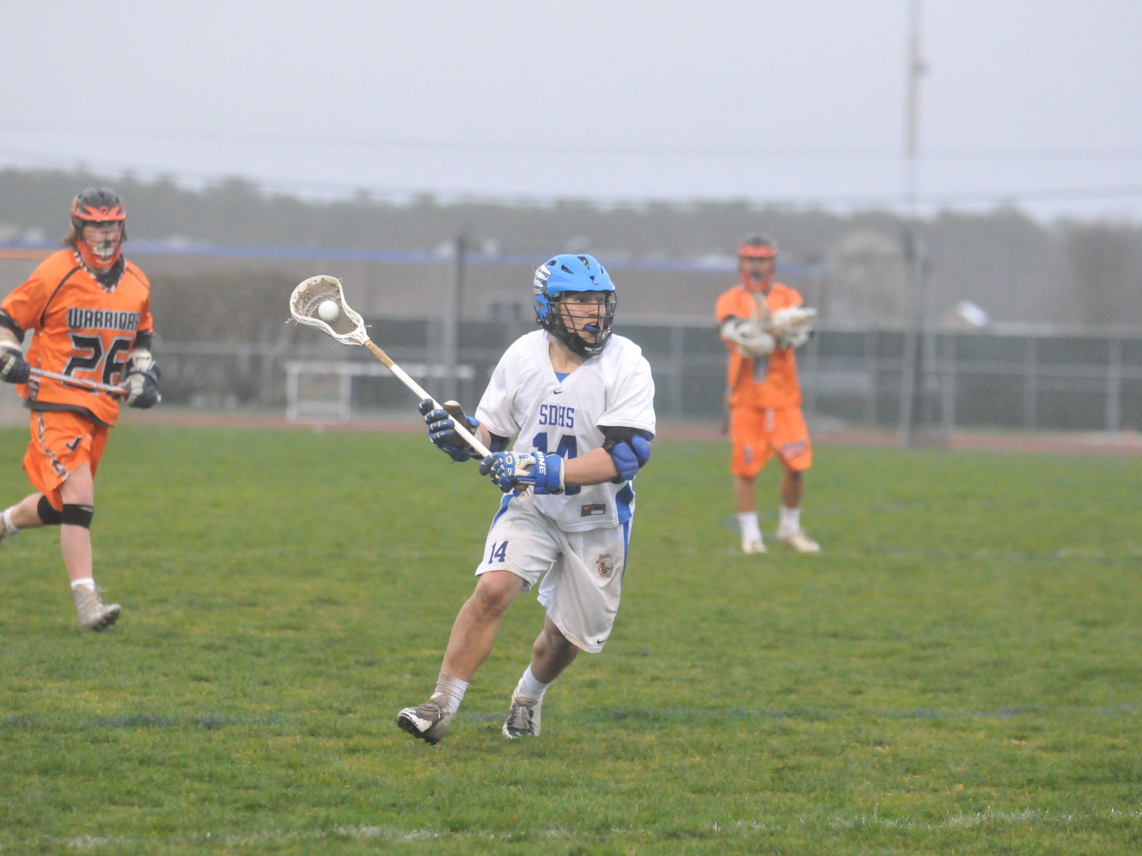 Stephen Decatur junior Dryden Brous looks for a pass during a game against Easton. The faceoff man has helped Decatur become a Bayside contender with the return of other players.