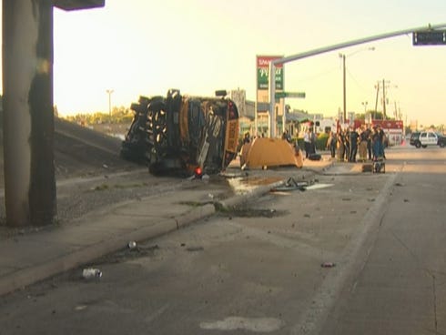 A school bus from the Houston Independent School District sits on its side Tuesday, Sept. 15, 2015, after it flipped off an overpass. One person was killed and several were injured.