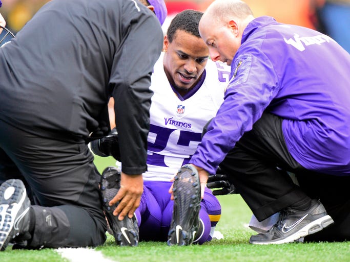 Minnesota Vikings cornerback Shaun Prater is checked by trainers after an injury on the field during the first quarter against the Cincinnati Bengals.