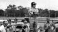 Driver Gary Bettenhausen stands near his car while watching his brother Merle Bettenhausen drive around the State Fairgrounds dirt track. Neither Bettenhausen made the race which was rain delayed by one week in 1973.