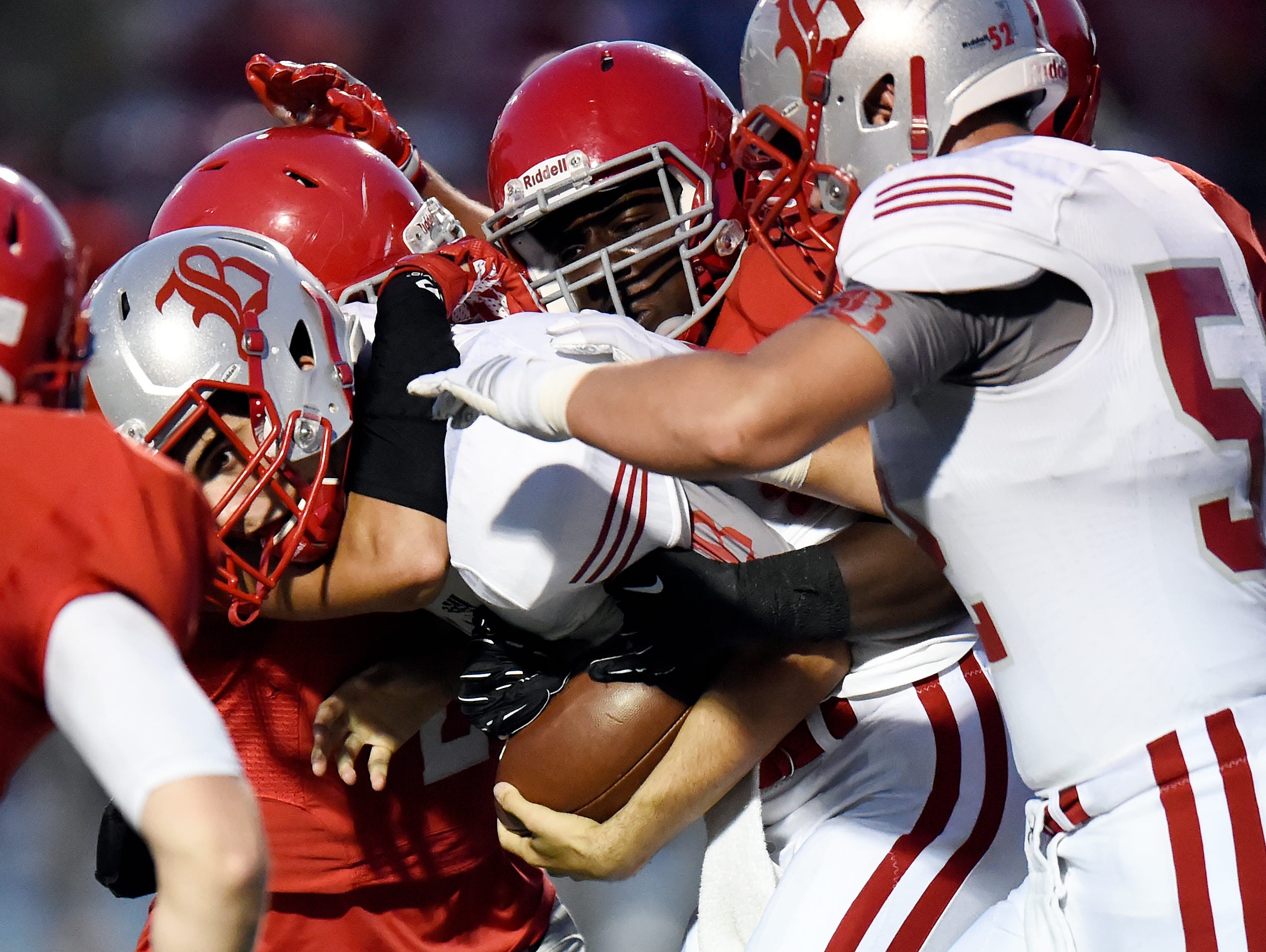 Baylor quarterback Lorenzo White, center, is sacked by Brentwood Academy defenders during first half of an high school football game on Friday, Sept. 16, 2016, in Brentwood, Tenn.