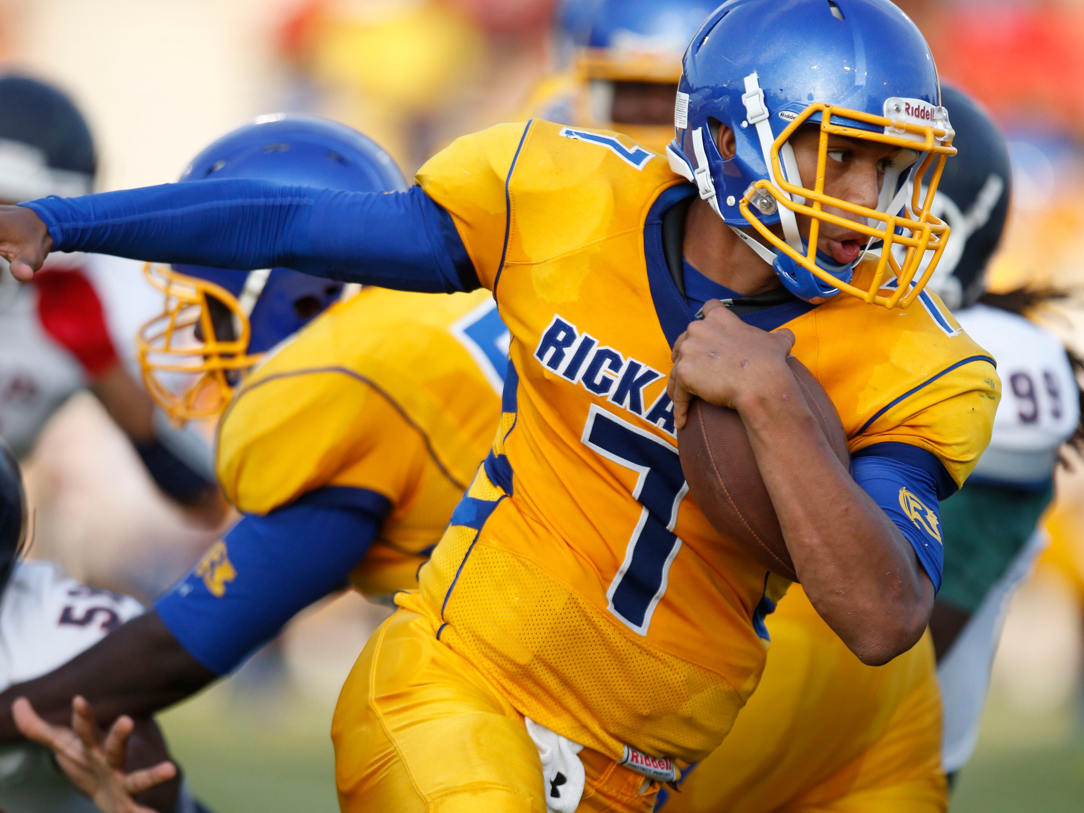Rickards quarterback DJ Phillips runs the ball against Wakulla during a jamboree at Gene Cox Stadium on Thursday.