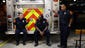 Firefighters talk outside of Station 1 in Lansing Wednesday,