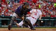 May 19: Rockies catcher Tony Wolters receives the throw