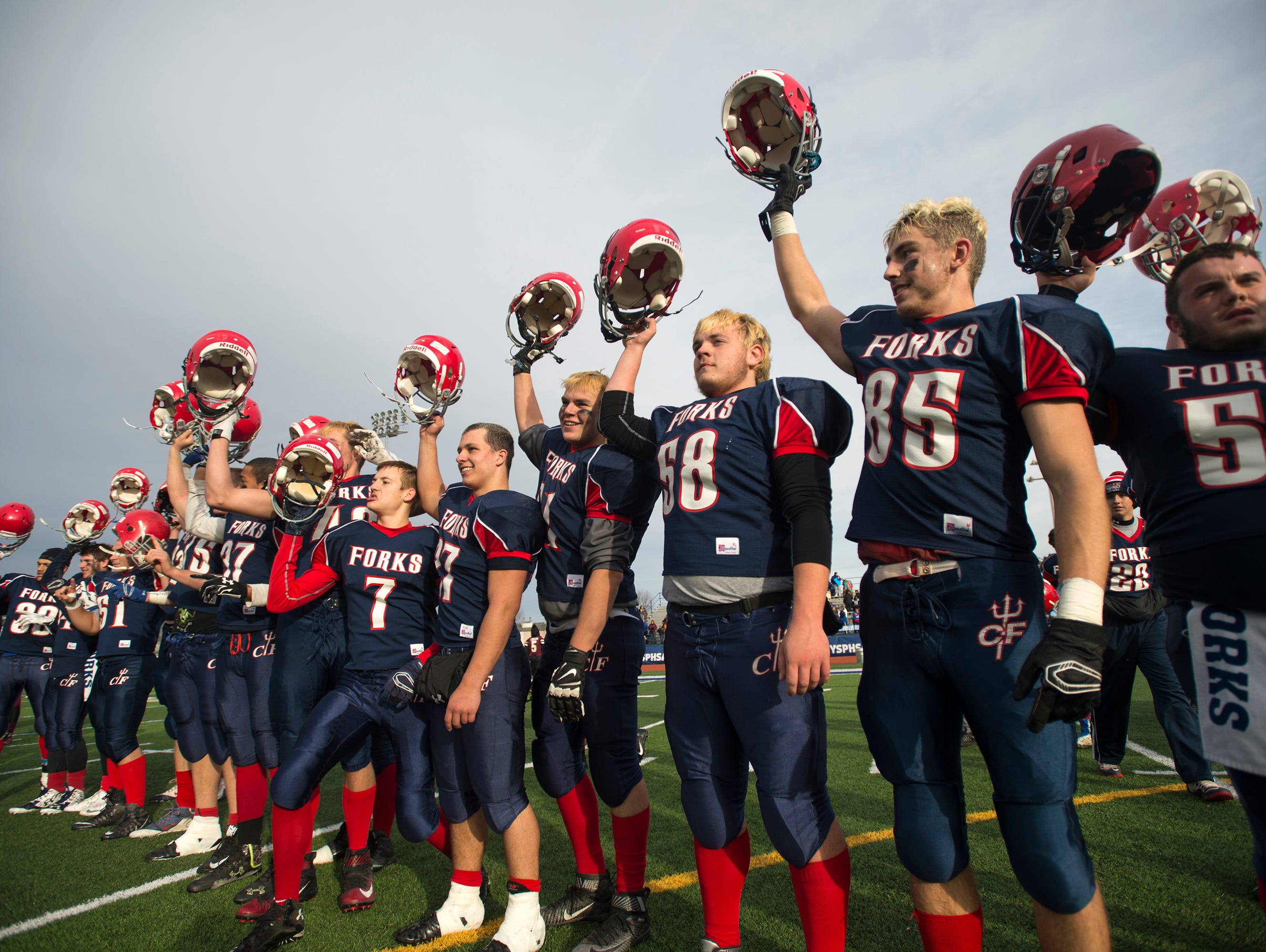 Chenango Forks players celebrate after beating Bath 44-22 to advance to the Class C state playoff finals.