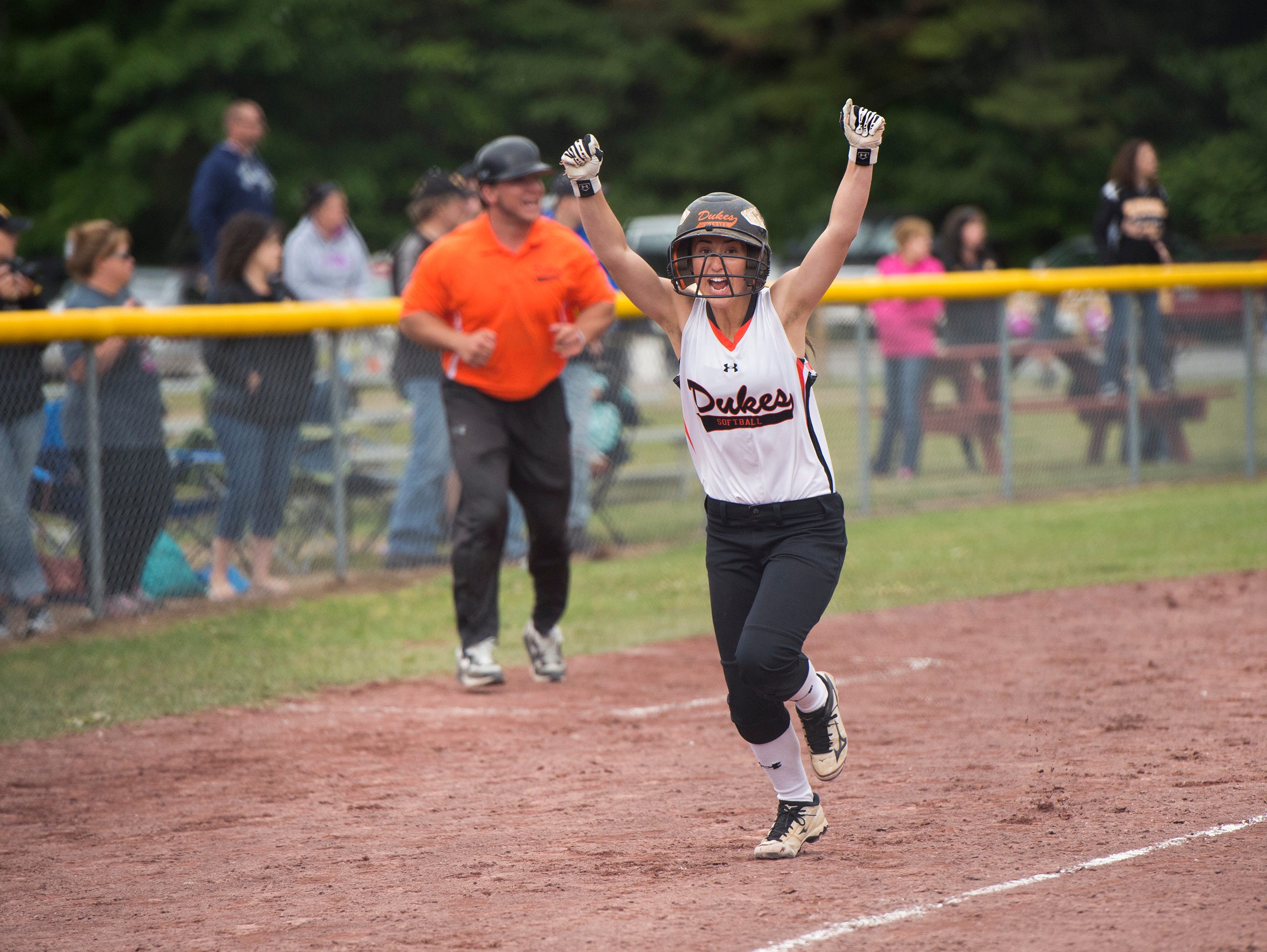 Marlboro High School's Taylor Felicello celebrates as she runs home to score the winning run in the Class B state title game on Sunday against Windsor.