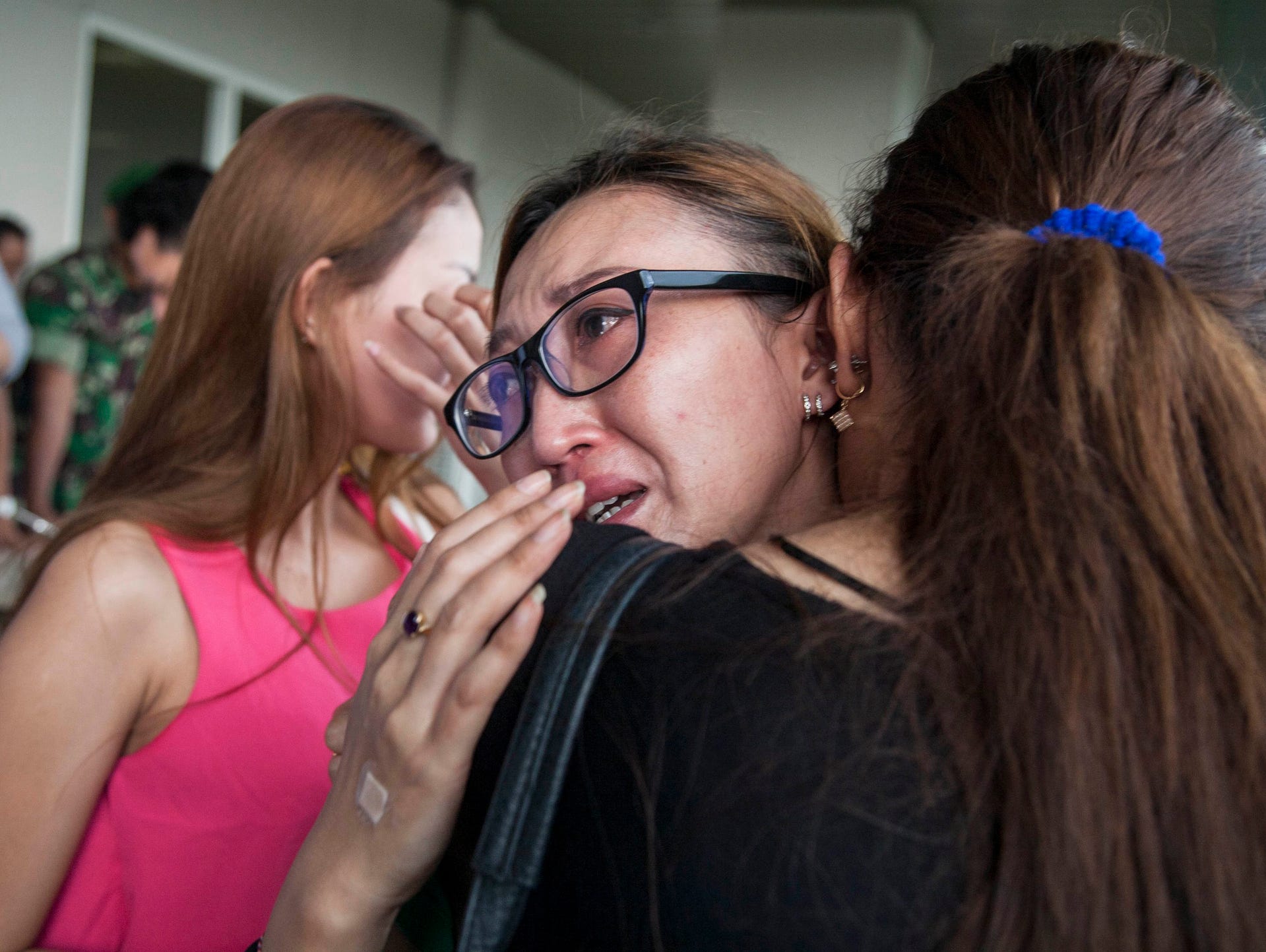 Weeping relatives await news of the AirAsia missing