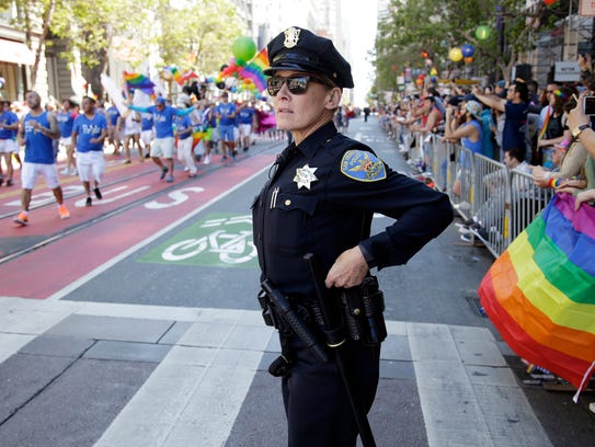 A police officer watches the San Francisco Gay Pride