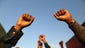 Demonstrators put their fists in the air as a sign