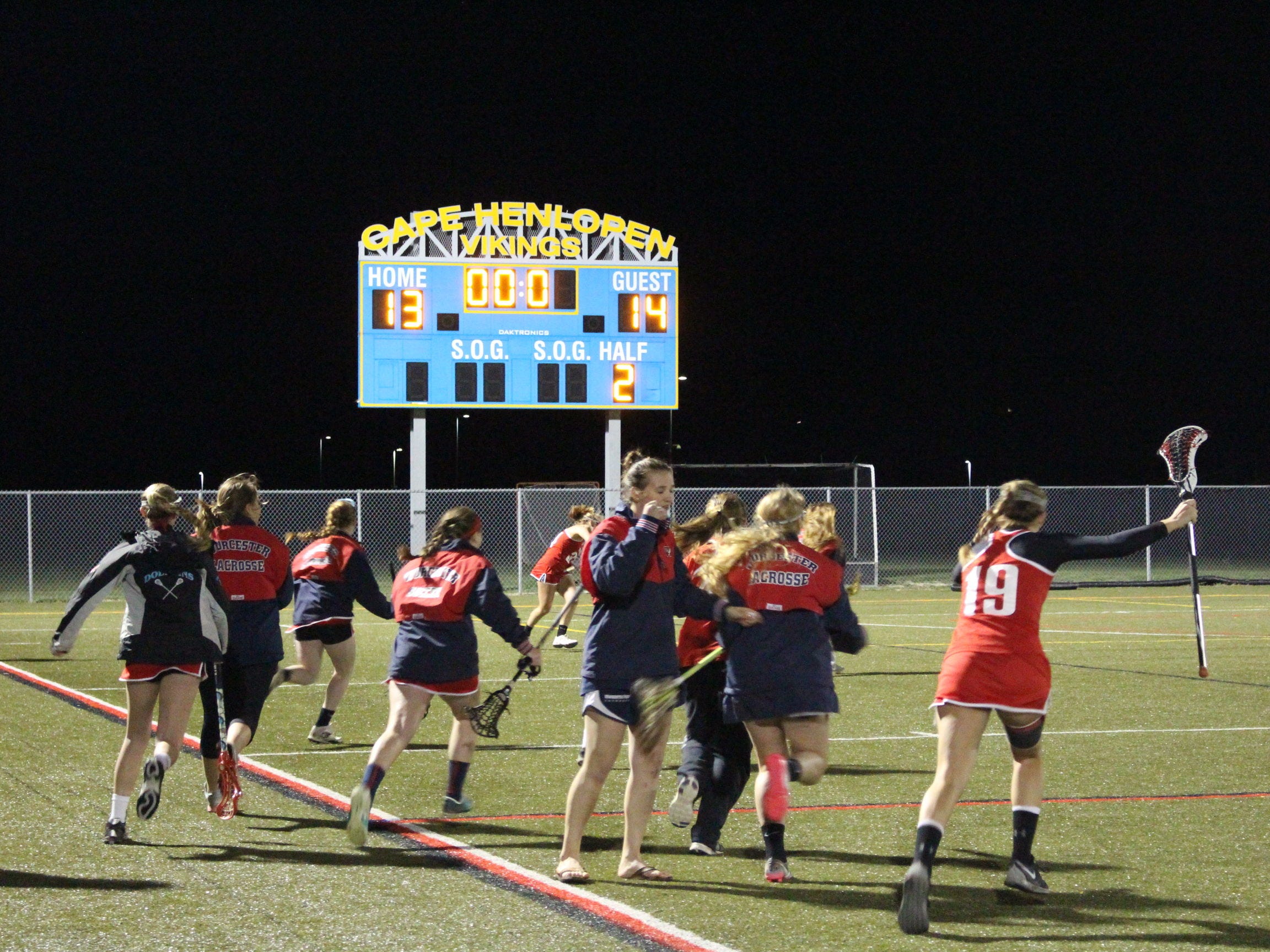 The Worcester Prep bench storm the field as the air horn sounds.