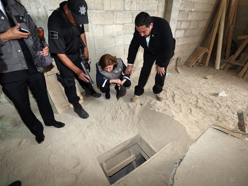 Handout photo released by the Attorney General of Mexico showing Mexico's Attorney General, Arely Gomez, looking at the alleged end of the tunnel through which Mexican drug lord Joaquin 