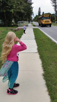 Children wait safely after sidewalks were put in at