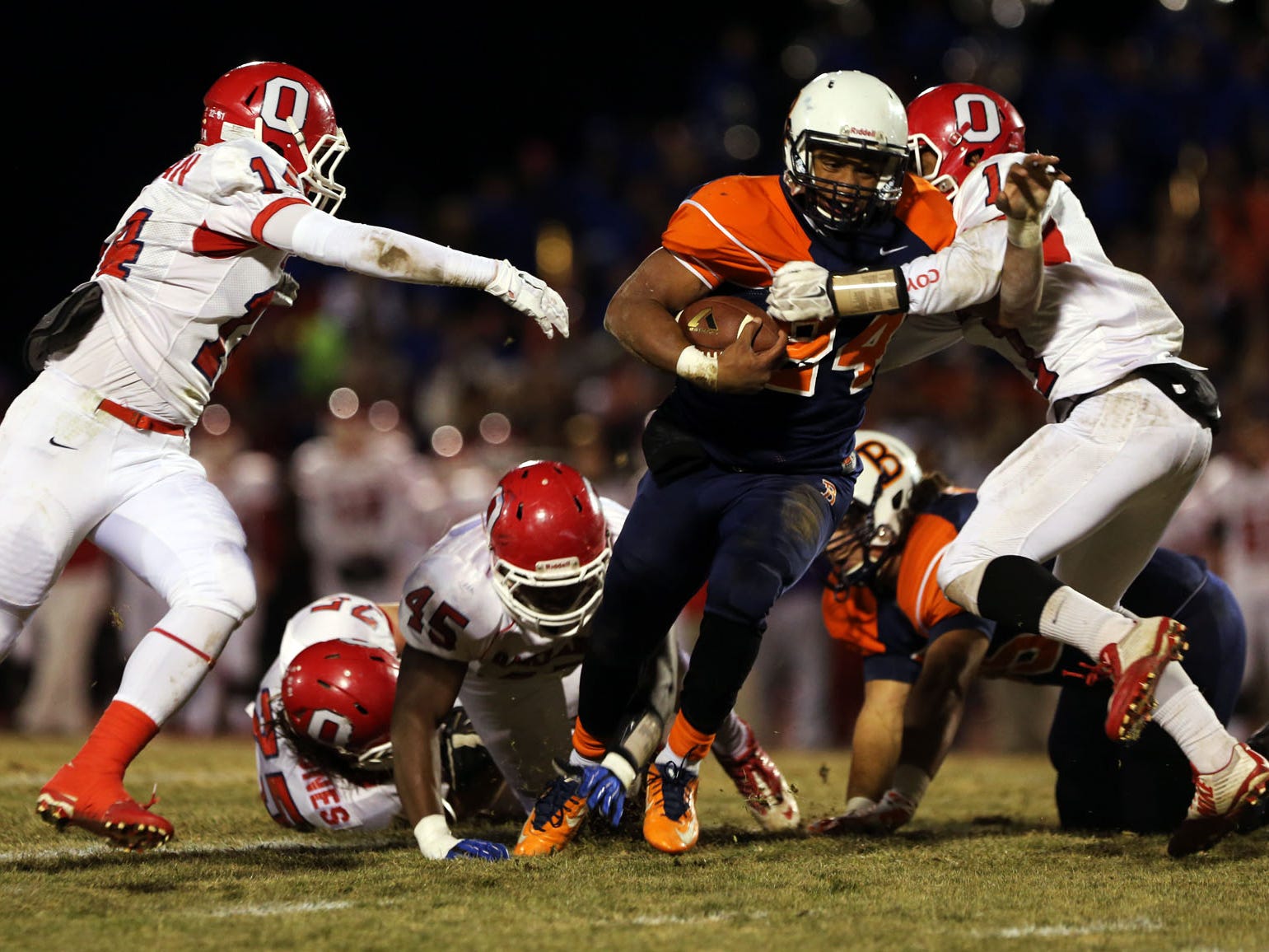 Blackman running back Charlie Davidson is hit by Oakland's Tyler Black, right, as Oakland's Cameron Newman closes in on the left in the first half of the play-off quarterfinal Friday, Nov. 21, 2014 at Blackman. Oakland won 20-9.