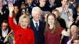 The Clintons acknowledge supporters during a caucus