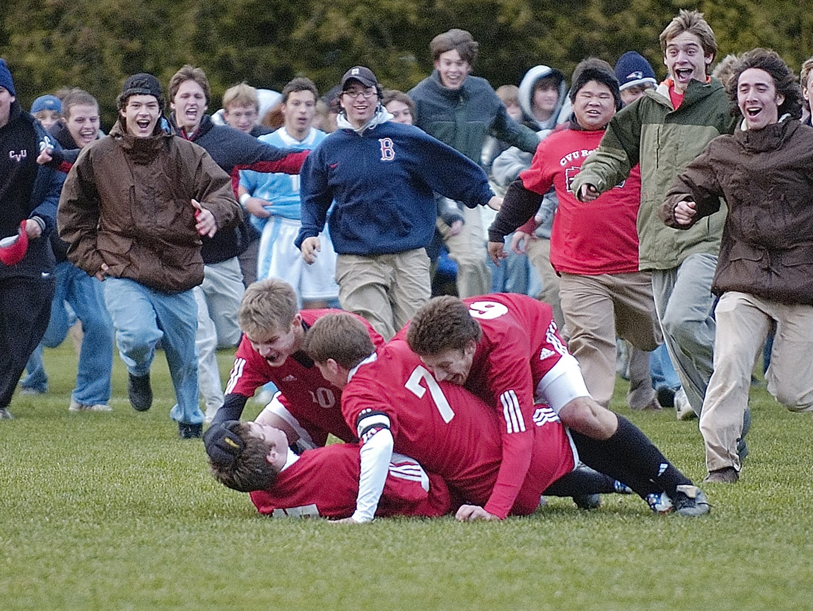 CVU’s Tyler Macnee (bottom left) is mobbed by teammates Micah Rose, Ethan Morrow and Ian Dudley after Macnee scored the winning goal in the 2006 Division I boys soccer final against South Burlington.