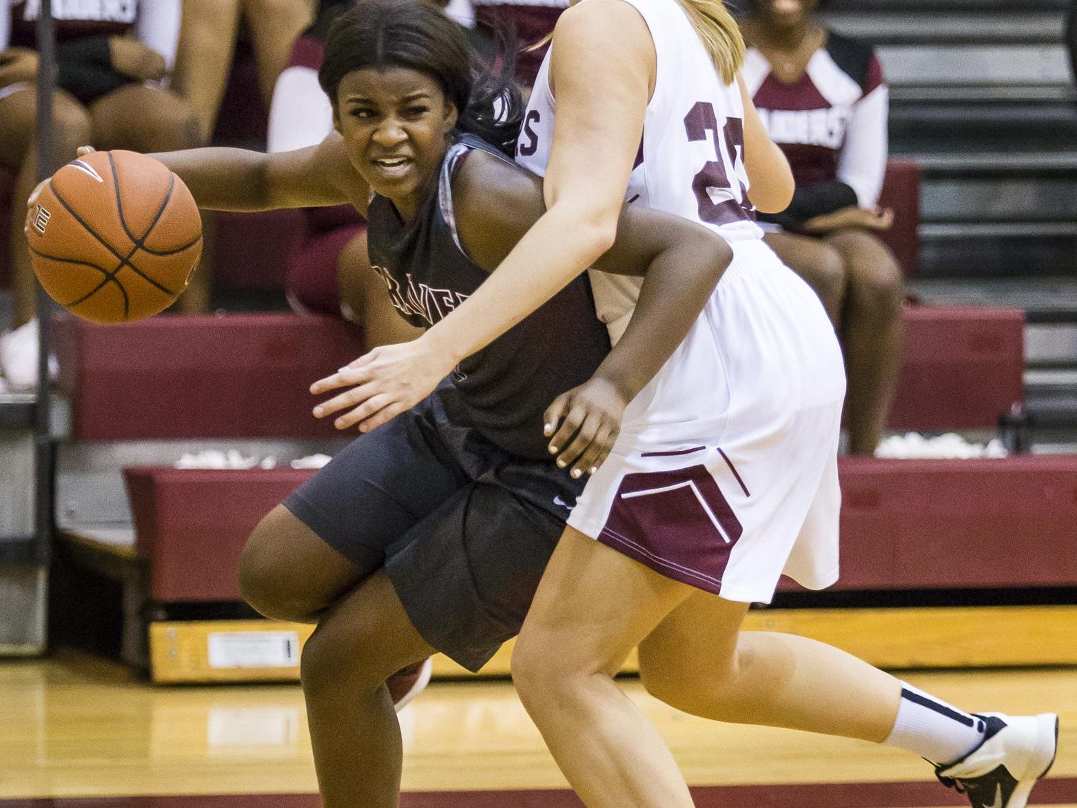 Caravel's Maia Bryson (left) tries to drive past a Concord defender in the first half of Caravel's 42-26 win over Concord at Concord High School on Monday night.