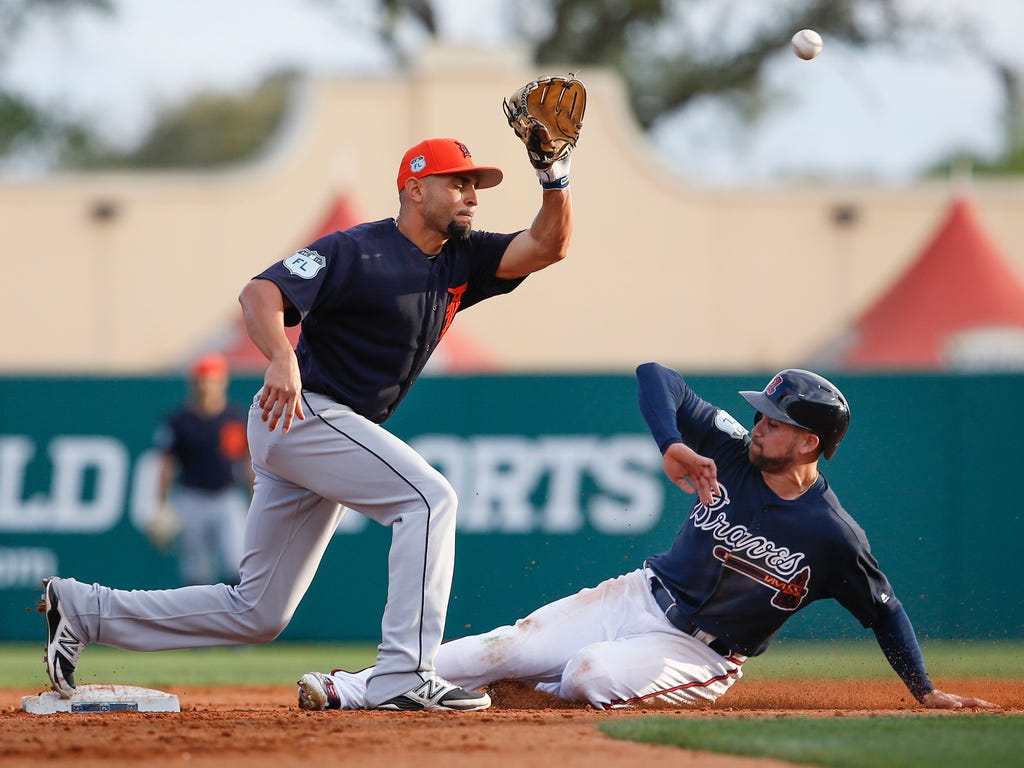 Atlanta Braves center fielder Ender Inciarte slides safely into second under a tag by Detroit Tigers second baseman Omar Infante during the third inning of an MLB spring training baseball game at Champion Stadium in Lake Buena Vista, Fla. The play wa