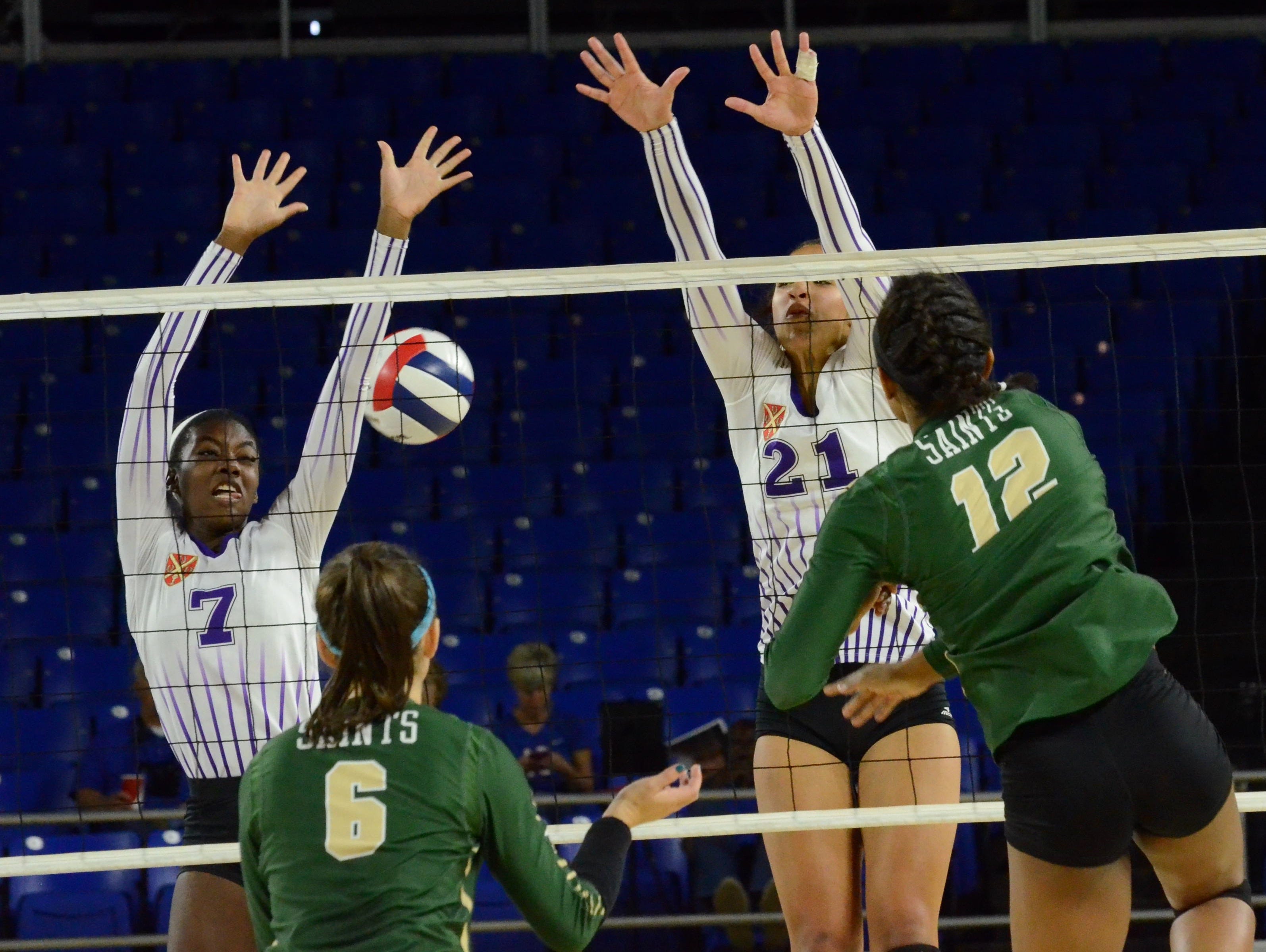 Father Ryan's Maxi Edwards (7) and Lauren Dorrell (21) attempt to block a Briarcrest kill during Friday's Division II-AA championship match at MTSU