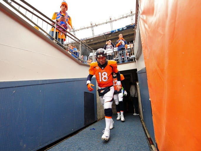 Denver Broncos quarterback Peyton Manning (18) walks