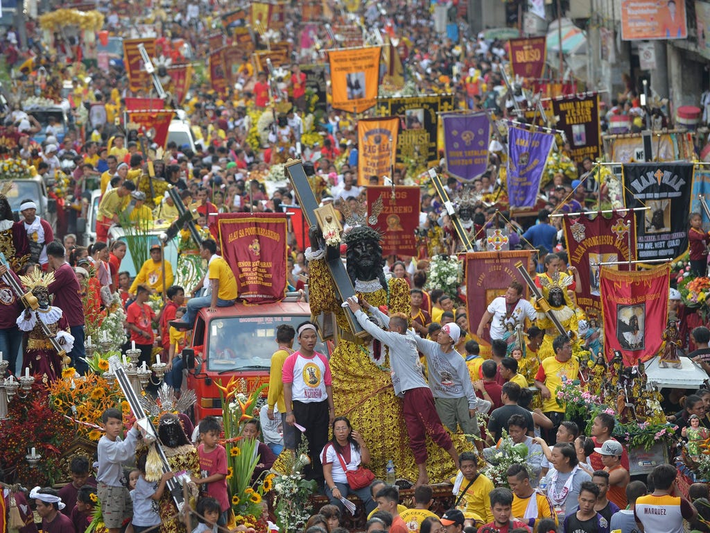 Devotees display replicas of the Black Nazarene during a procession outside Quiapo church in Manila on Jan. 7, 2018, ahead of the annual procession on January 9. Hundreds of thousands of barefoot devotees will on January 9 attend the annual religious
