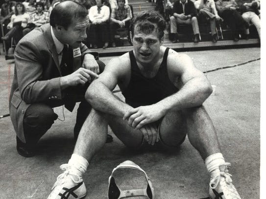 Iowa wrestling coach Dan Gable, left, talks to Ed Banach